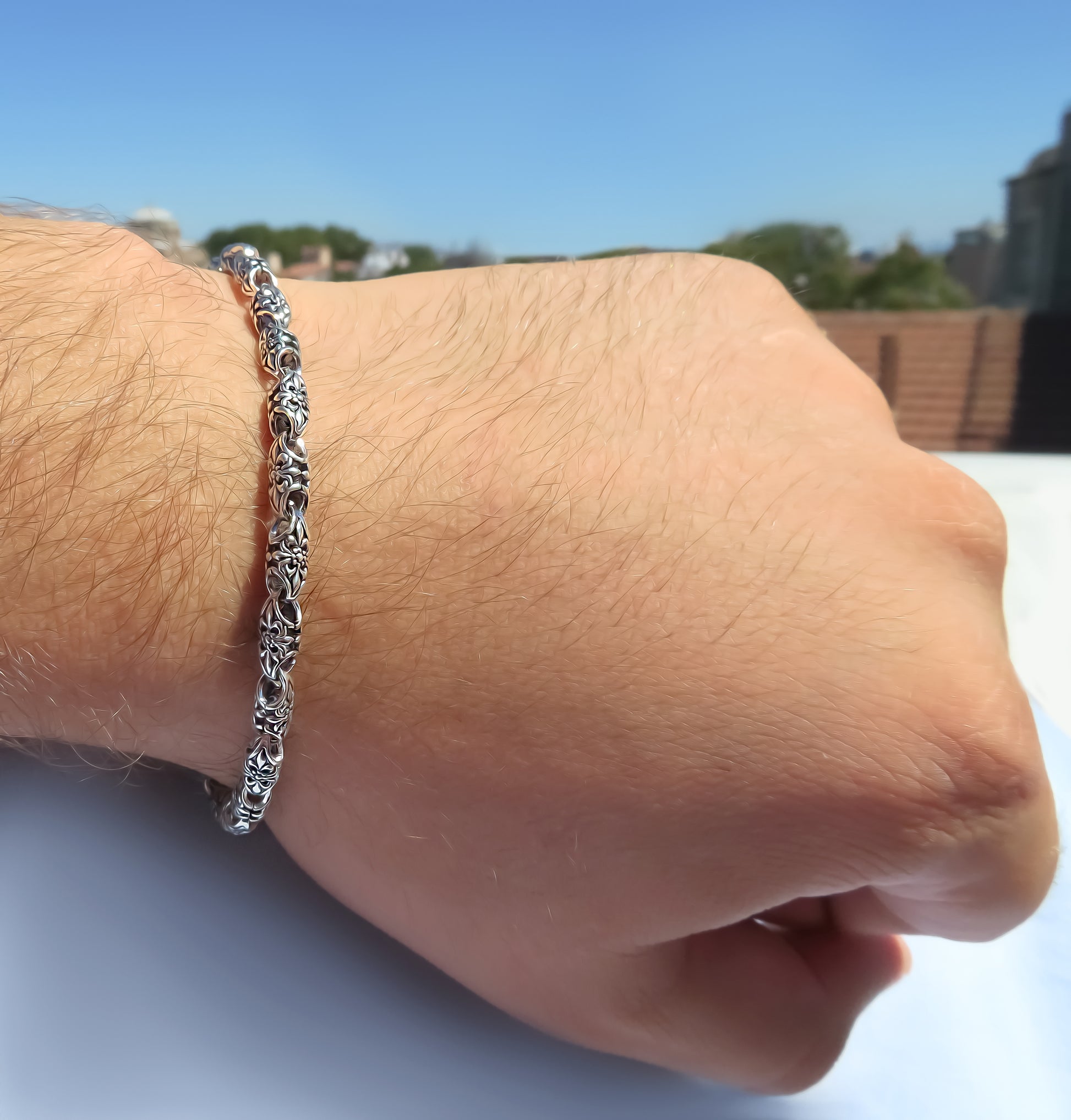 Chunky silver bracelet featuring 4.5mm floral links by Qutahia Jewellery.