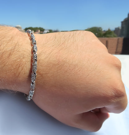 Chunky silver bracelet featuring 4.5mm floral links by Qutahia Jewellery.