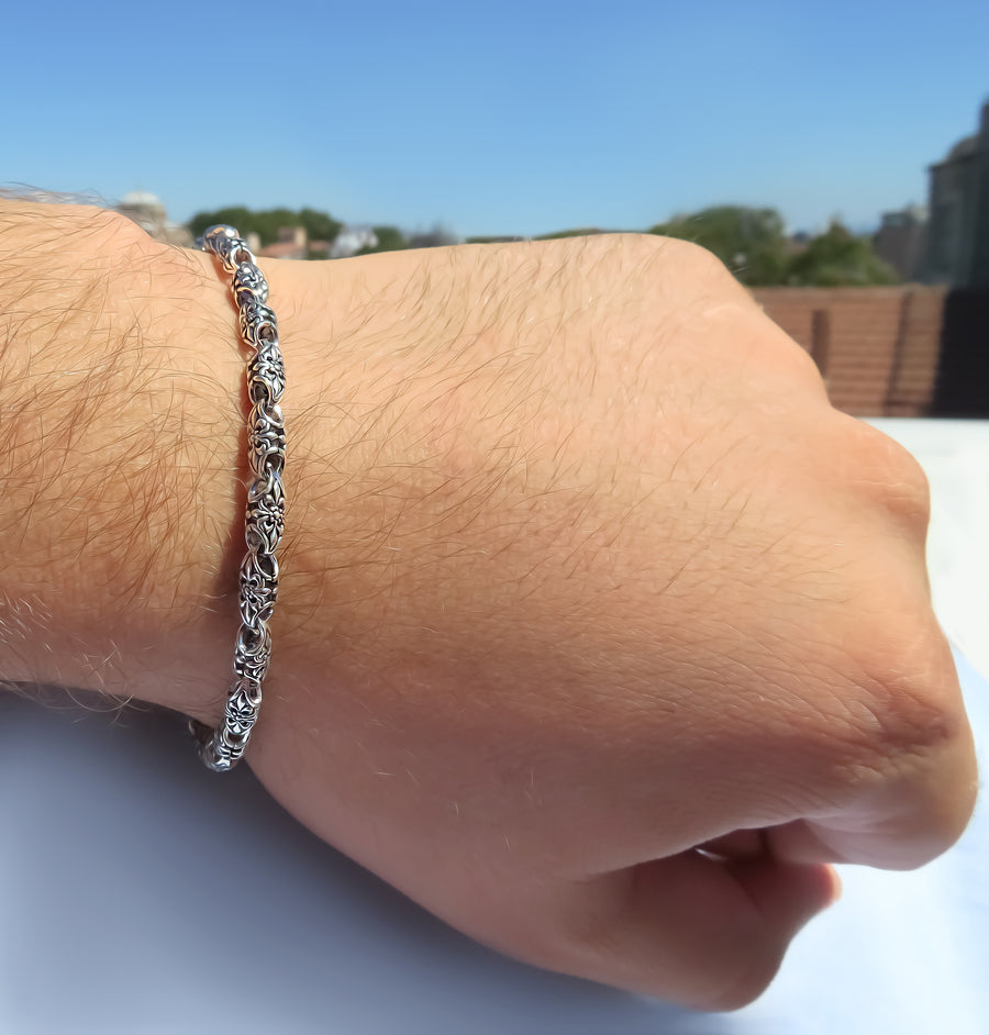 Chunky silver bracelet featuring 4.5mm floral links by Qutahia Jewellery.
