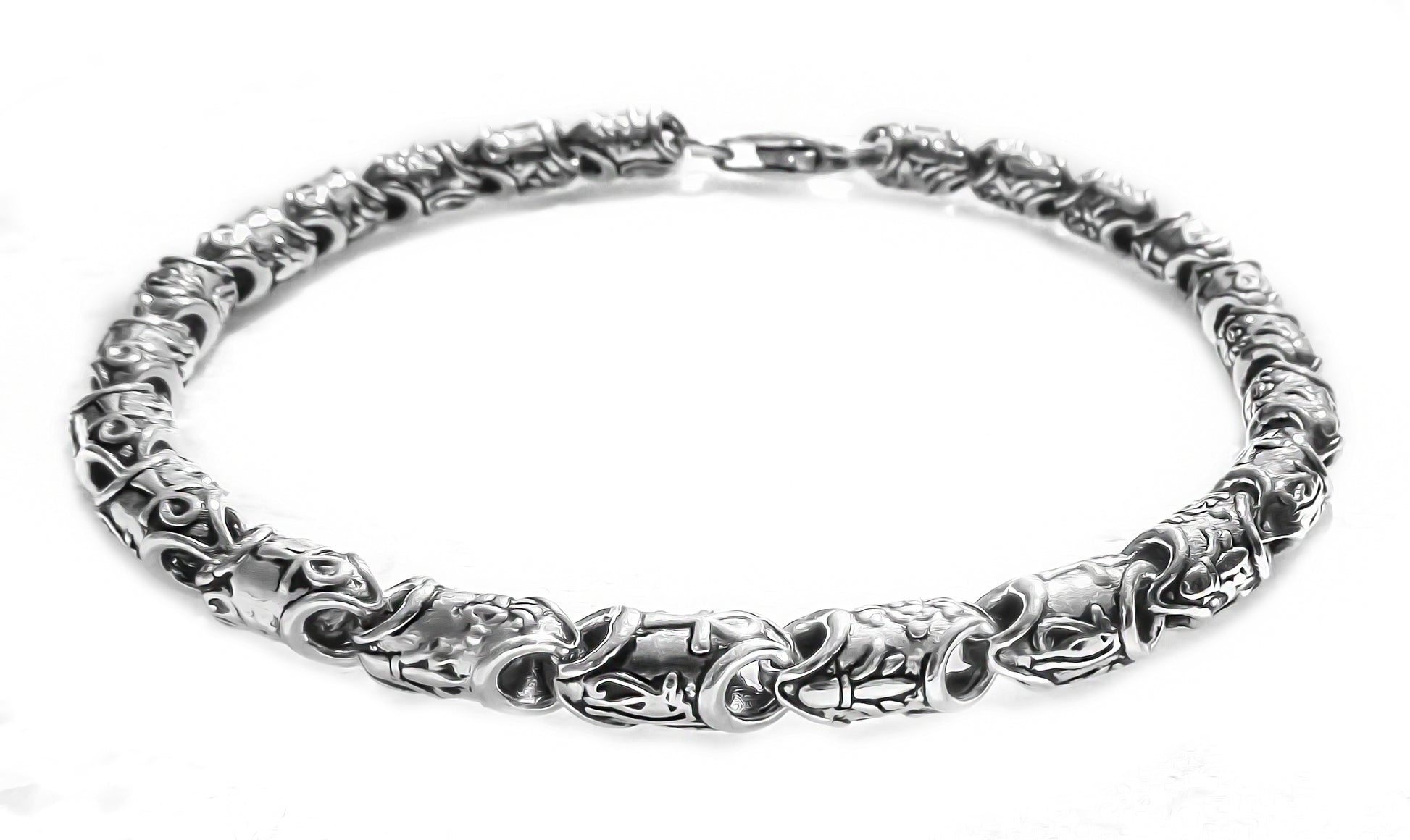 Chunky silver bracelet featuring Ankh and floral links by Qutahia Jewellery.